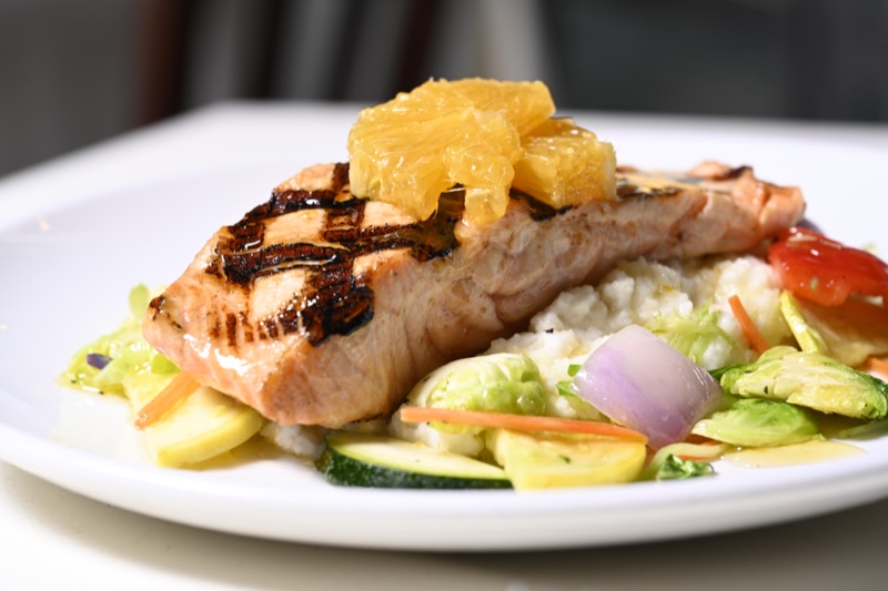 Caramelized orange salmon with grits and vegetables